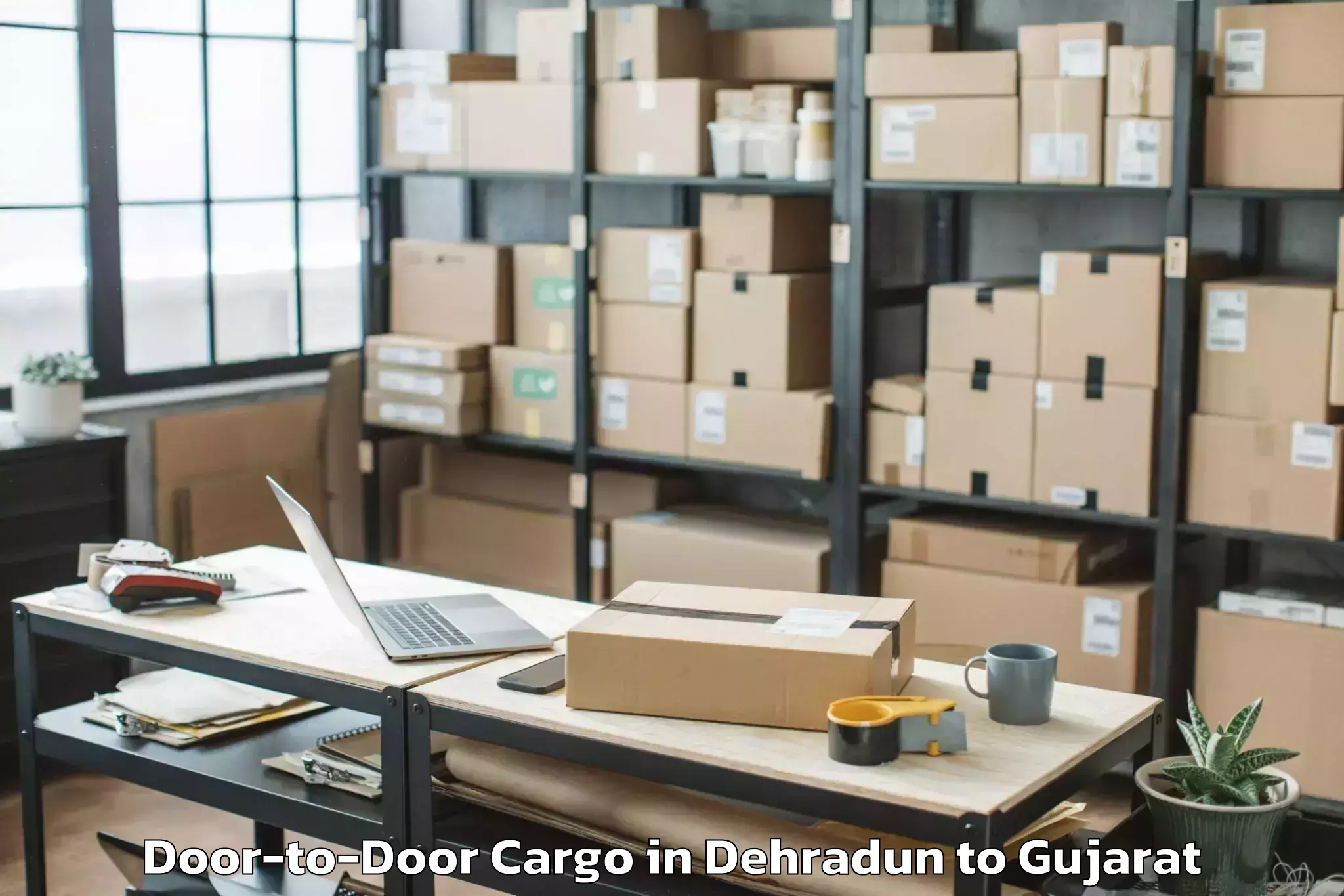 Expert Dehradun to Visavadar Door To Door Cargo